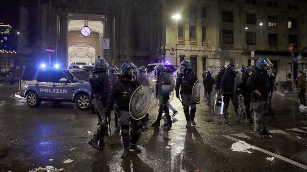 Police patrol outside the central train station, during a protest against the government restriction measures to curb the spread of COVID-19, in Milan Italy, Monday, Oct. 26, 2020. Italy's leader has imposed at least a month of new restrictions to fi