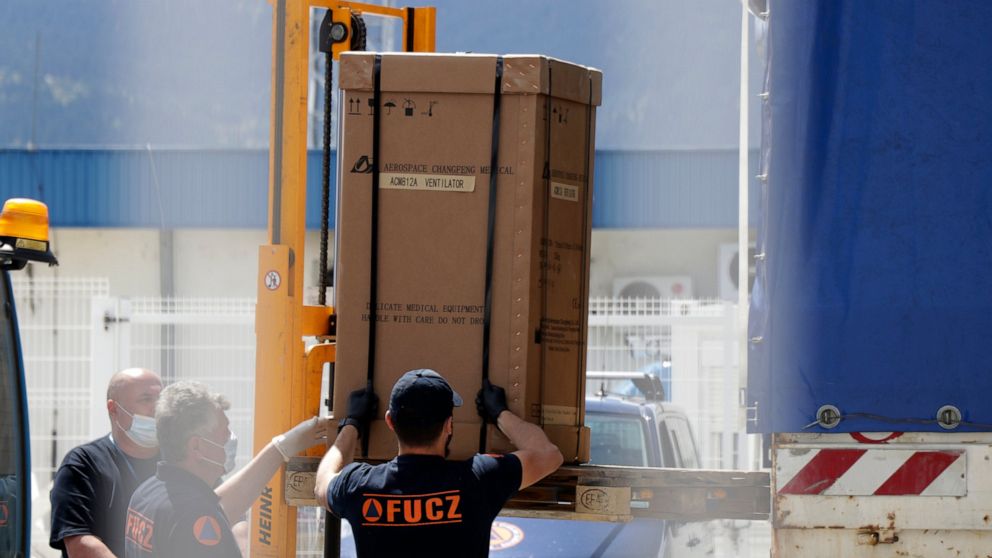 Civil protection workers move boxes of ventilators at the customs post in the Bosnia capital Sarajevo, Thursday, April 30, 2020. In their initial report, the Bosnian state prosecutors said in a statement released Monday May 11, 2020, that the ventila