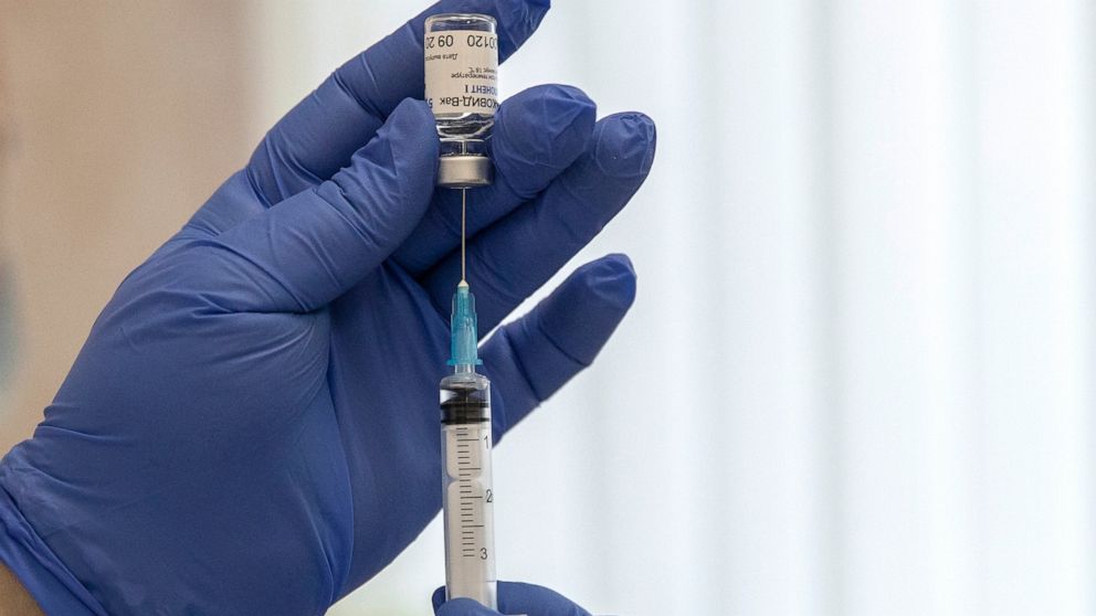 FILE - In this Dec. 10, 2020, file photo, a Russian medical worker prepares a shot of Russia's Sputnik V coronavirus vaccine in Moscow. Russia is turning to multiple Chinese firms to manufacture the Sputnik V coronavirus vaccine in an effort to speed