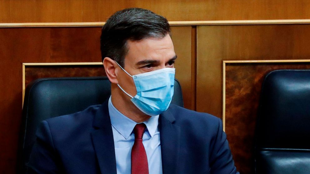 Spain's Prime Minister Pedro Sanchez sits in the Spanish parliament wearing a protective face mask in Madrid, Spain, Wednesday May 20, 2020. Sanchez is appearing before the Parliament to ask for their endorsement to extend the nation's state of emerg