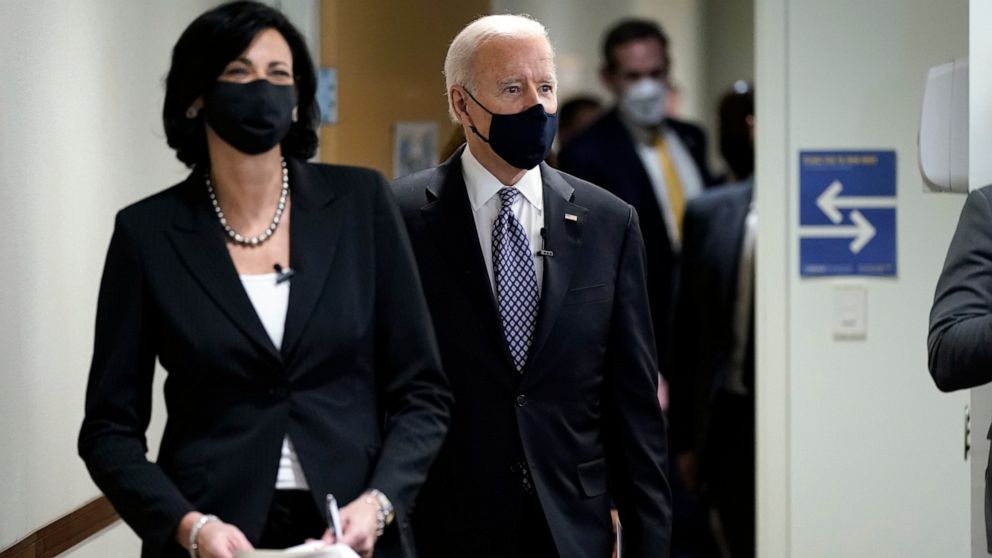 In this March 19, 2021, photo, Dr. Rochelle Walensky, director of the Centers for Disease Control and Prevention, leads President Joe Biden into the room for a COVID-19 briefing at the headquarters for the CDC Atlanta. Walensky is making an impassion
