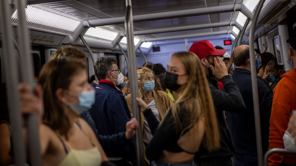 Commuters wearing face masks to protect against the spread of Coronavirus travel by train in Barcelona, Spain, Saturday, May 15, 2021. (AP Photo/Emilio Morenatti)