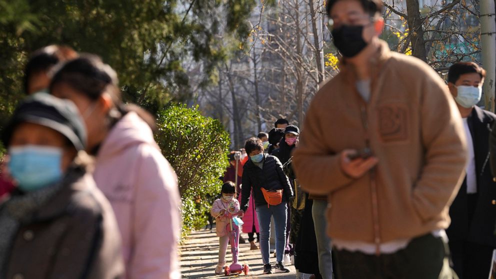 Residents wearing masks line up for COVID tests in Beijing, Tuesday, Nov. 15, 2022. China's ruling party called for strict adherence to the hard-line "zero-COVID" policy Tuesday in an apparent attempt to guide public perceptions after regulations wer