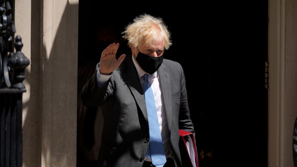 British Prime Minister Boris Johnson waves at the media as he leaves 10 Downing Street to attend the weekly Prime Minister's Questions at the Houses of Parliament, in London, Wednesday, June 16, 2021. (AP Photo/Matt Dunham)