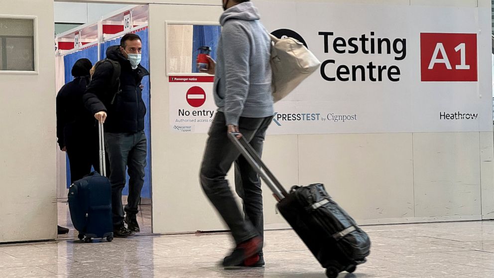 FILE - Passengers get a COVID-19 test at Heathrow Airport in London, Nov. 29, 2021. The Biden administration is lifting its requirement that international air travelers to the U.S. take a COVID-19 test within a day before boarding their flights, easi
