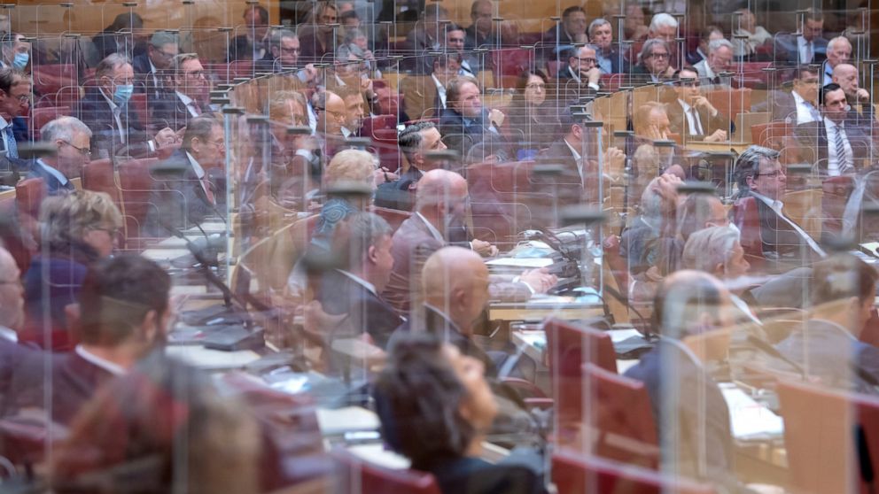 The members of the Bavarian state parliament follow the government speech of the Bavarian Minister President behind plexiglass partitions in Munich, Germany, Friday, Oct. 30, 2020. Federal and state governments have decided on a partial lockdown star