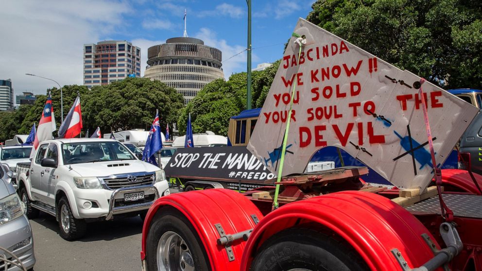 A convoy of vehicles block a road near New Zealand's Parliament in Wellington Tuesday, Feb. 8, 2022. Hundreds of people protesting vaccine and mask mandates drove in convoy to New Zealand's capital on Tuesday and converged outside Parliament as lawma