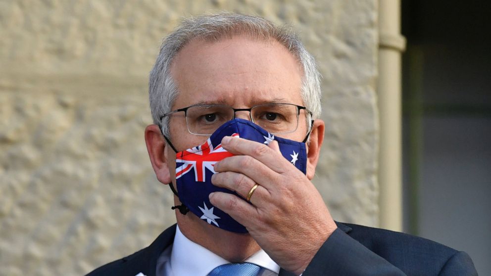 Australian Prime Minister Scott Morrison adjusts his mask during the announcement of a COVID-19 financial support package in Sydney, Tuesday, July 13, 2021. Morrison announced added financial support for businesses and households as Sydney appears in