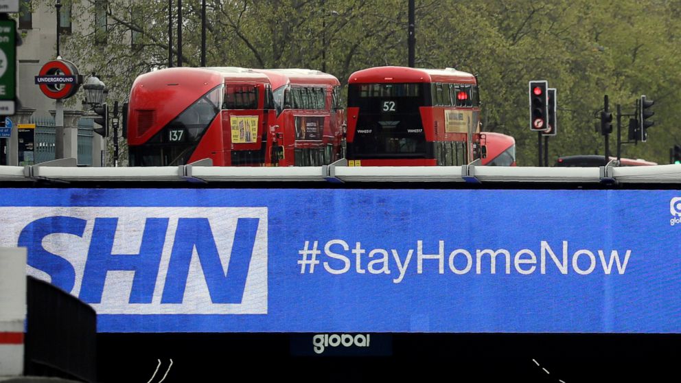 FILE - In this Monday, April 13, 2020 file photo, a sign above an underpass in London advises drivers to stay at home, as the country is in lockdown to help curb the spread of the coronavirus. Rates of depression appear to have almost doubled in Brit