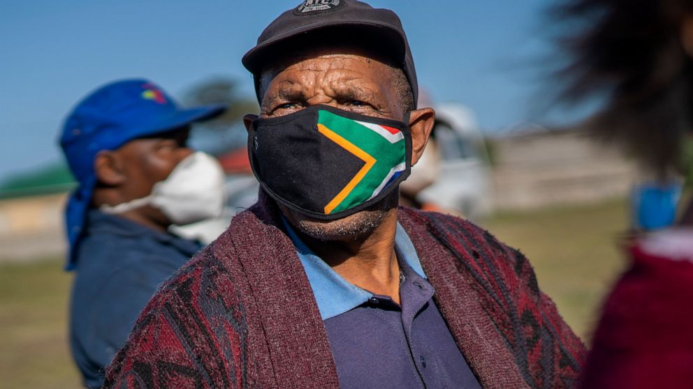 A man waits at the Swartkops railroad yard to receive a COVID-19 vaccination outside Gqeberha, South Africa, Wednesday Sept. 22, 2021. South Africa has sent a train carrying COVID-19 vaccines into one of its poorest provinces to get doses to areas wh
