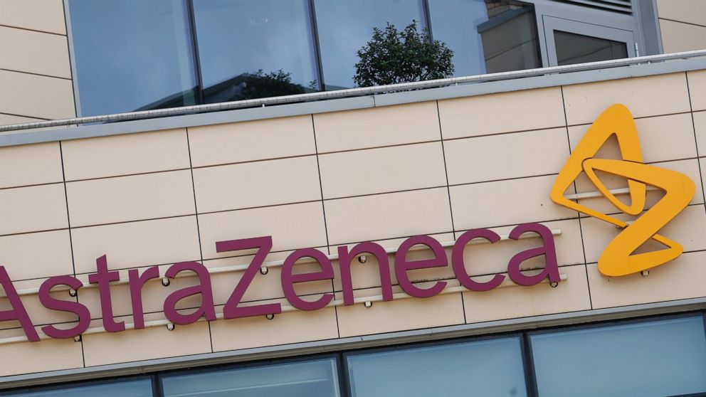 FILE - This Saturday, July 18, 2020 file photo shows a general view of AstraZeneca offices and the corporate logo in Cambridge, England. Late stage trials into a coronavirus vaccine developed by Oxford University and drugmaker AstraZeneca were paused