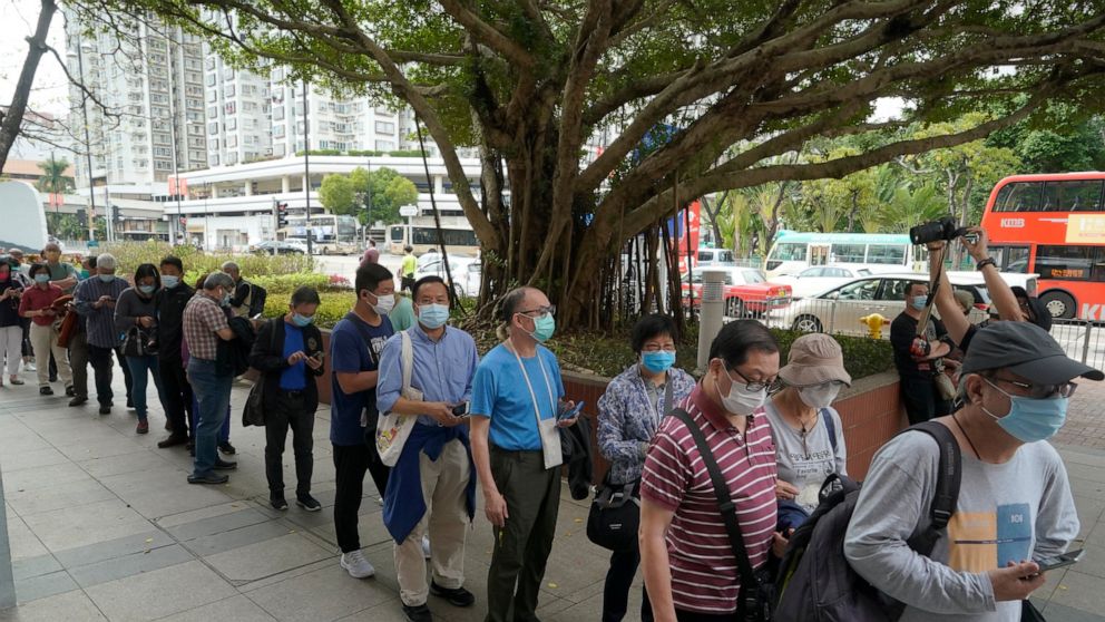 FILE - In this Friday, Feb. 26, 2021 file photo, people line up to receive China's Sinovac COVID-19 coronavirus vaccine at a community vaccination center in Hong Kong. Hong Kong authorities on Tuesday, March 2 reported the death of a chronically ill 