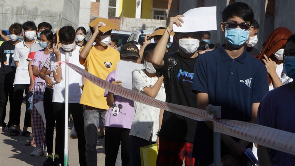 Young people line up for receiving shot of the Sinovac's COVID-19 vaccine at the Phnom Penh Thmey Health Center, during a campaign in Phnom Penh, Cambodia, Sunday, Aug. 1, 2021. Cambodia on Sunday began its inoculation campaign against the COVID-19 v