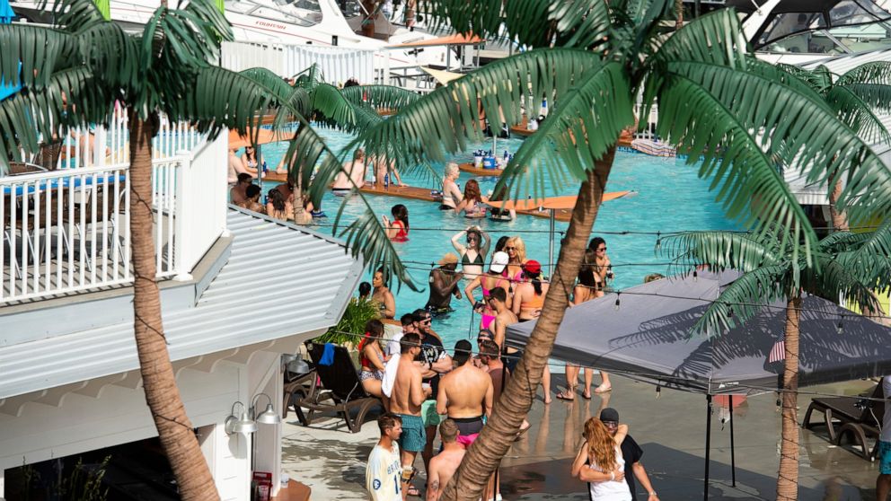Crowds of people gather at Coconuts Caribbean Beach Bar & Grill in Gravois Mills, Missouri, Sunday, May 24, 2020. Several beach bars along Lake of the Ozarks were packed with party-goers during the Memorial Day weekend. Several political leaders in t