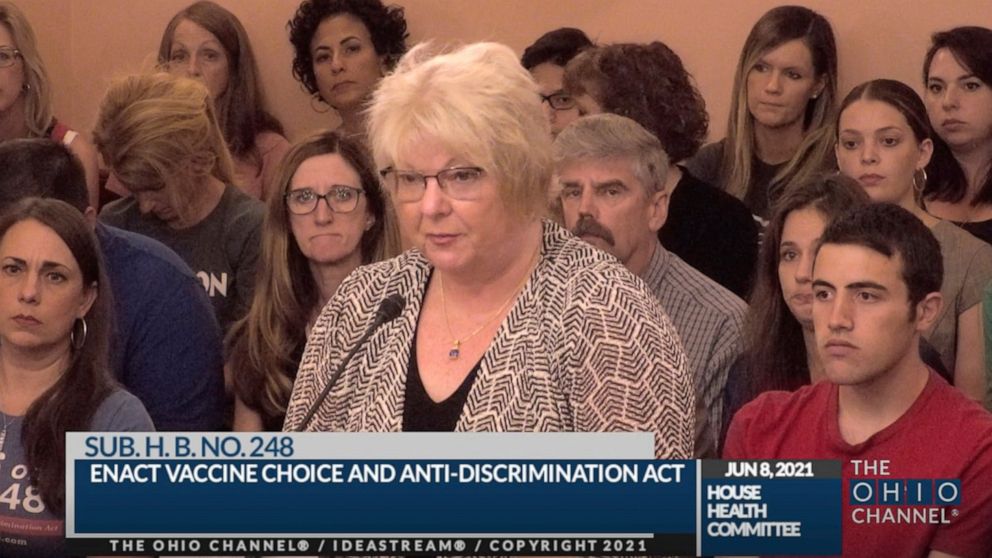 In this June 8, 2021, photo provided by the The Ohio Channel, Dr. Sherri Tenpenny speaks at a Ohio House Health Committee in Columbus, Ohio. The Cleveland-based osteopathic doctor testified that COVID-19 vaccines cause magnetism. “They can put a key 