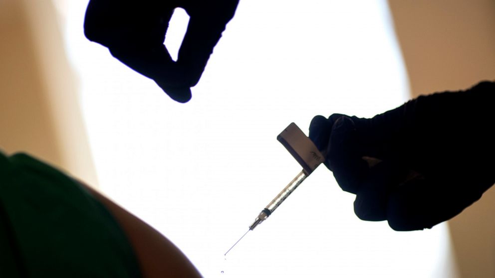 FILE - In this Tuesday, Dec. 15, 2020, file photo, a droplet falls from a syringe after a health care worker was injected with the Pfizer-BioNTech COVID-19 vaccine at a hospital in Providence, R.I. The U.S. COVID-19 vaccination campaign has begun, an