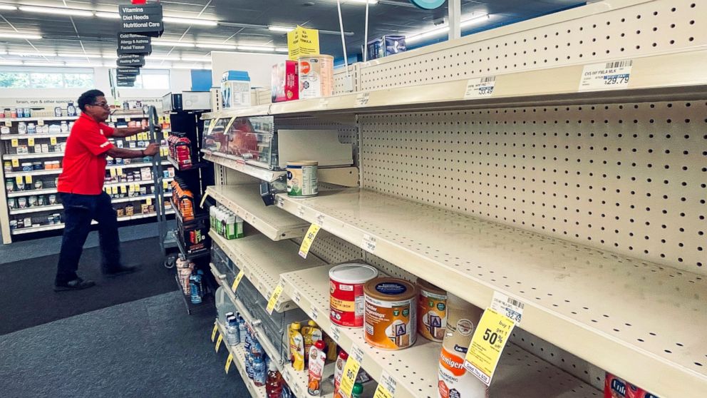 An employee walks near empty shelves where baby formula would normally be located at a CVS in New Orleans on Monday, May 16, 2022. President Joe Biden's administration has announced new steps to ease the national shortage of baby formula, including a