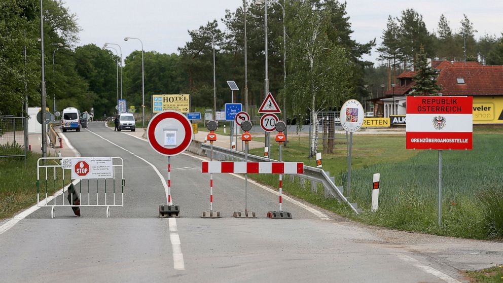 FILE - In this May 13, 2020 file photo, a barrier blocks the road at the closed border crossing from Austria to the Czech Republic near Reinthal, Austria. European Union countries are set to adopt a common traffic light system to coordinate traveling