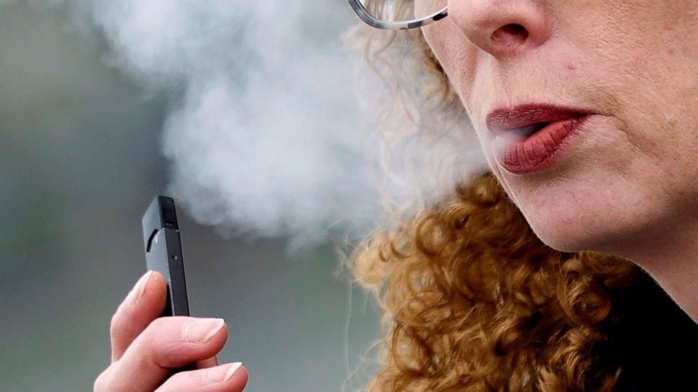 FILE — A woman exhales while vaping from a Juul pen e-cigarette in Vancouver, Wash., April 16, 2019. Federal health officials on Thursday,June 23, 2022 ordered Juul to pull its electronic cigarettes from the U.S. market, the latest blow to the embatt