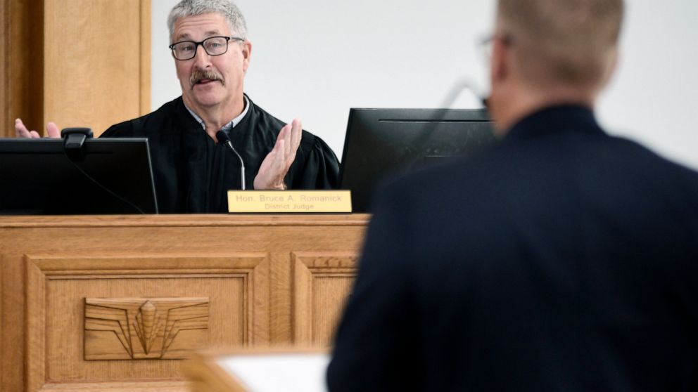 FILE - South Central District Judge Bruce Romanick, left, asks a question during a preliminary injunction hearing regarding banning abortions on Aug. 19, 2022, in Bismarck, N.D. On Monday, Oct. 31, 2022, Romanick affirmed his refusal to let the state