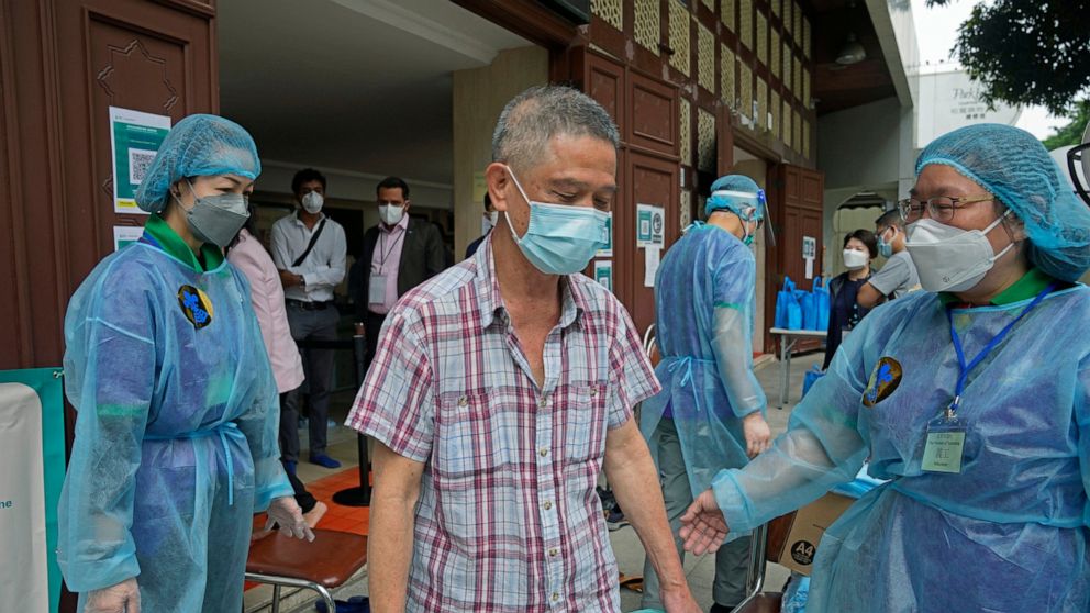 A man leaves after receiving a dose of the Pfizer-BioNTech COVID-19 coronavirus vaccine at a community vaccination center at the Kowloon Mosque And Islamic Centre in Hong Kong, Saturday, March 19, 2022. Hong Kong's cumulative coronavirus infections h