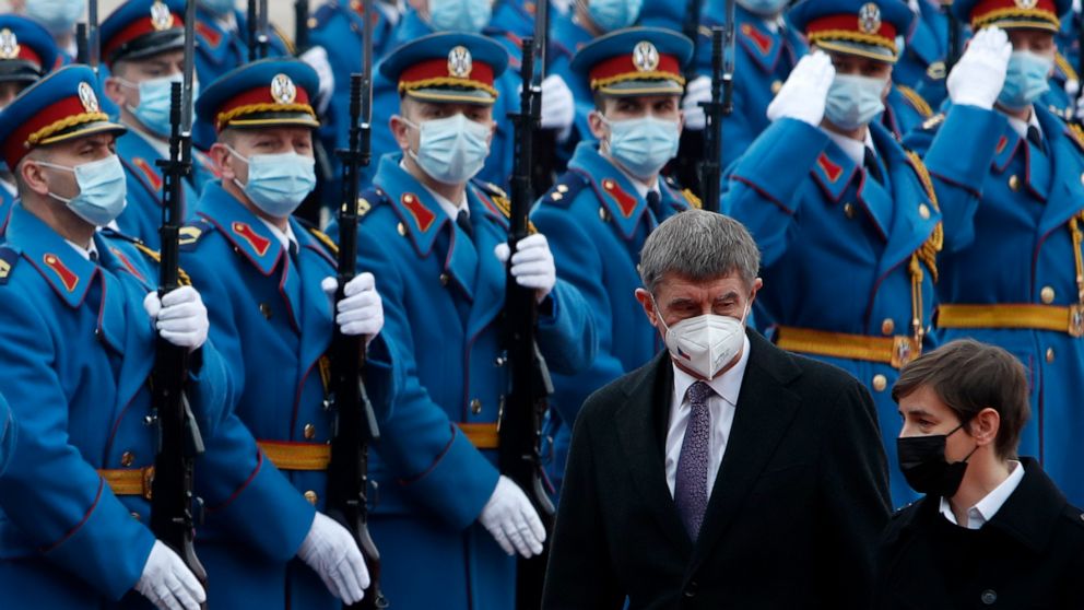 Czech Prime Minister Andrej Babis, centre, reviews the honor guard during a welcome ceremony with his Serbian counterpart Ana Brnabic, right, before their official talks at the Serbia Palace in Belgrade, Serbia, Wednesday, Feb. 10, 2021. Babis is on 