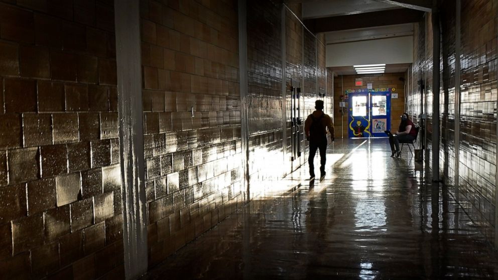 FILE - A student walks down a hallway between classes at a high school in Kansas City, Kan., on the first day of in-person learning Wednesday, March 30, 2021. According to a study by the Centers for Disease Control and Prevention released on Thursday