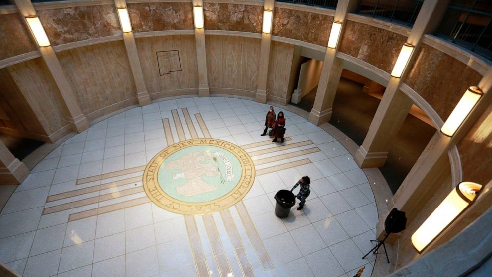 FILE - People walk under the state Capitol rotunda during the annual legislative session on Feb. 2, 2022, in Santa Fe, N.M. A legislative panel on Tuesday, July 12, 2022, listened to advocates who hope to broaden the scope of medical treatment and re