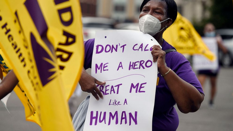 FILE - Clarissa Johnson of Hartford marches with long-term care members of the New England Health Care Employees Union, during a rally to demand new laws to protect long-term caregivers and consumers, July 23, 2020, at the State Capitol in Hartford, 