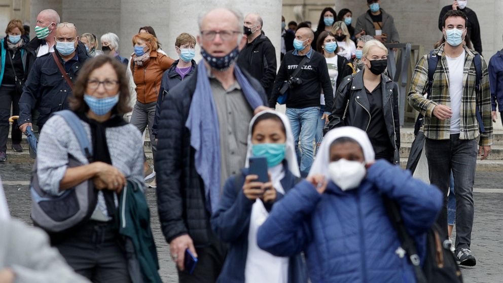 Faithful and nuns wear face masks to stop the spread of COVID-19, at the Vatican, Tuesday, Oct. 6, 2020. Italy's health minister said that the government is examining a proposal to make masks mandatory outdoors as the country enters a difficult phase