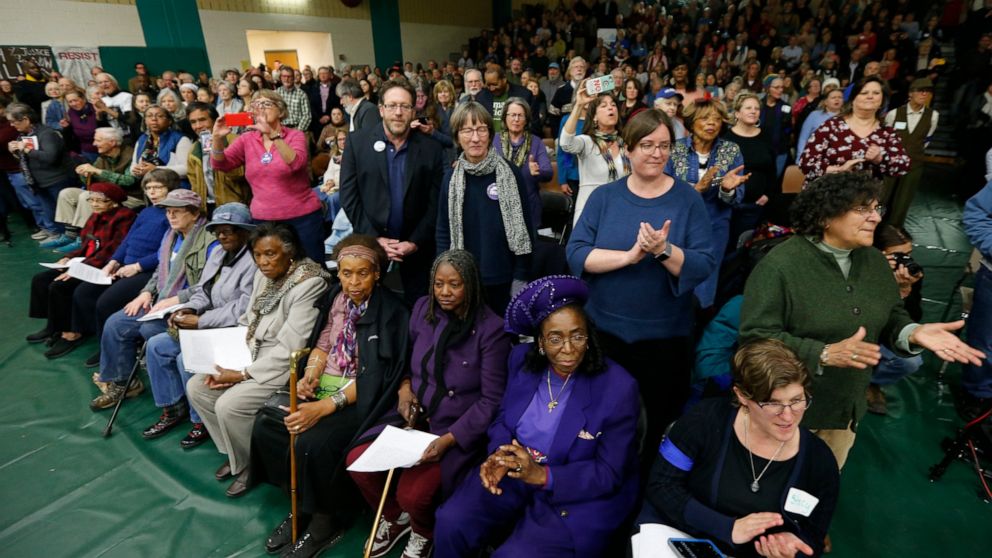 FILE - In this Feb. 19, 2019, file photo, residents of Buckingham County sing along as a Town Hall meeting about a proposed compressor station in Union Hill, Va., for the Atlantic Coast Pipeline. A federal appeals court has thrown out a permit needed