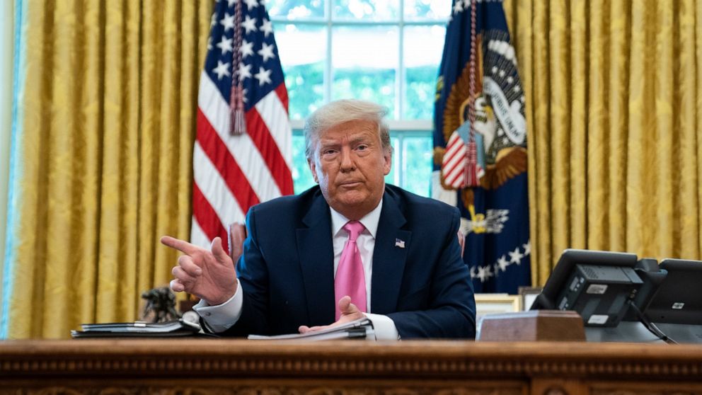 President Donald Trump points to the door as reporters are escorted out of a meeting with with Senate Majority Leader Mitch McConnell of Ky., and House Minority Leader Kevin McCarthy of Calif., in the Oval Office of the White House, Monday, July 20, 