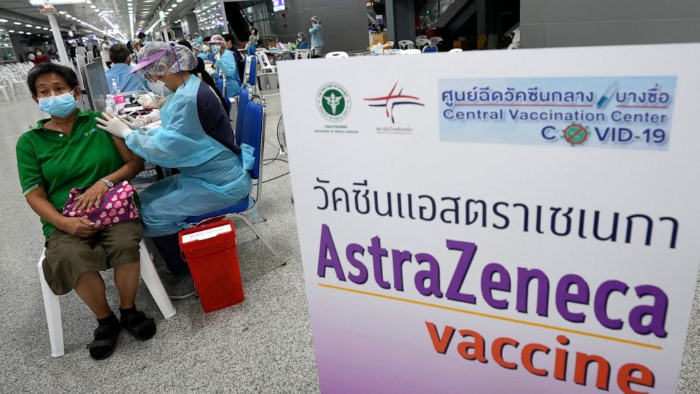 A health worker administers a dose of the AstraZeneca COVID-19 vaccine to a woman at Central Vaccination Center in Bangkok, Thailand, Wednesday, July 14, 2021. Health authorities in Thailand said Wednesday they will seek to put limits on the export o
