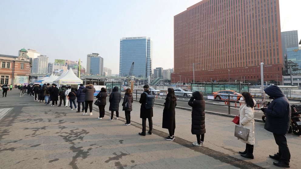People wait for their coronavirus test at a makeshift testing site in Seoul, South Korea, Saturday, Feb. 26, 2022. South Korea had its deadliest day of the pandemic on Saturday, reporting more than a hundred fatalities in the latest 24-hour period, a