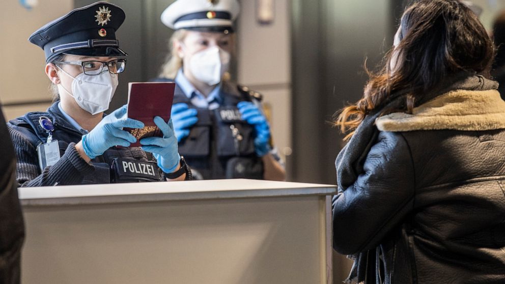 Officers of the German Federal Police check passengers arriving with a plane from Prague at the Frankfurt Airport in Frankfurt, Germany, Sunday, Jan 24, 2021. Anyone how is entering Germany from countries classify as high-risk countries by the federa