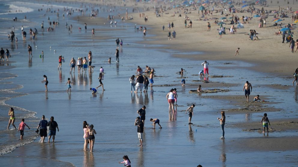 FILE — People enjoy the beach, Feb. 12, 2022, Santa Monica, Calif. California's population continued to shrink in 2021 as the nation's most populous state posted its second consecutive decline, state officials said Monday, May 2, 2022. (AP Photo/Mike
