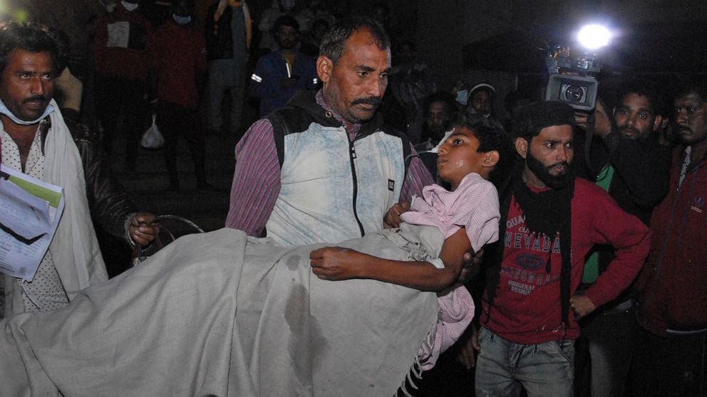 A man carries a child out from the Kamla Nehru Children’s Hospital after a fire in the newborn care unit of the hospital killed four infants, in Bhopal, India, Monday, Nov. 8, 2021. There were 40 children in total in the unit, out of which 36 have be
