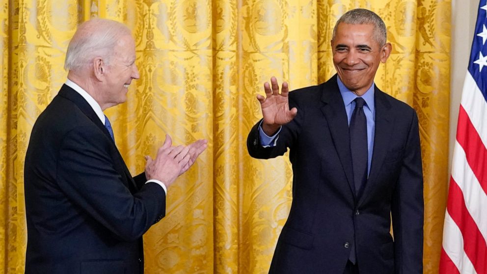 President Joe Biden applauds as former President Barack Obama arrives on stage during an event about the Affordable Care Act, in the East Room of the White House in Washington, Tuesday, April 5, 2022. (AP Photo/Carolyn Kaster)