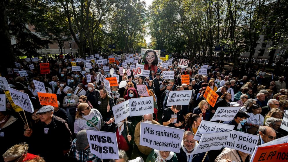People gather during a protest in support of public health care in downtown Madrid, Spain, Sunday, Nov. 13, 2022. Tens of thousands of public health workers and their supporters are demonstrating in the Spanish capital to demand more staff in primary