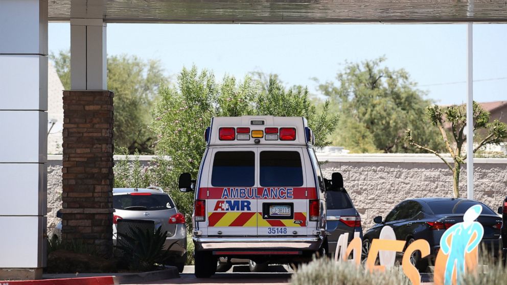 FILE - In this June 10, 2020, file photo, an ambulance is parked at Arizona General Hospital in Laveen, Ariz. Arizona is continuing to see slight downward trends with coronavirus hospitalizations as officials find more related deaths. Arizona is comm