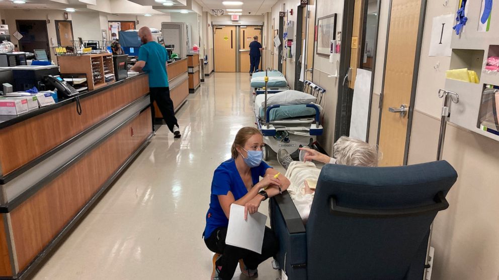 FILE - A nurse talks to a patient in the emergency room at Salem Hospital in Salem, Ore., on Aug. 20, 2021. Oregon voters are being asked in the November election to decide whether the state should be the first in the nation to amend its Constitution