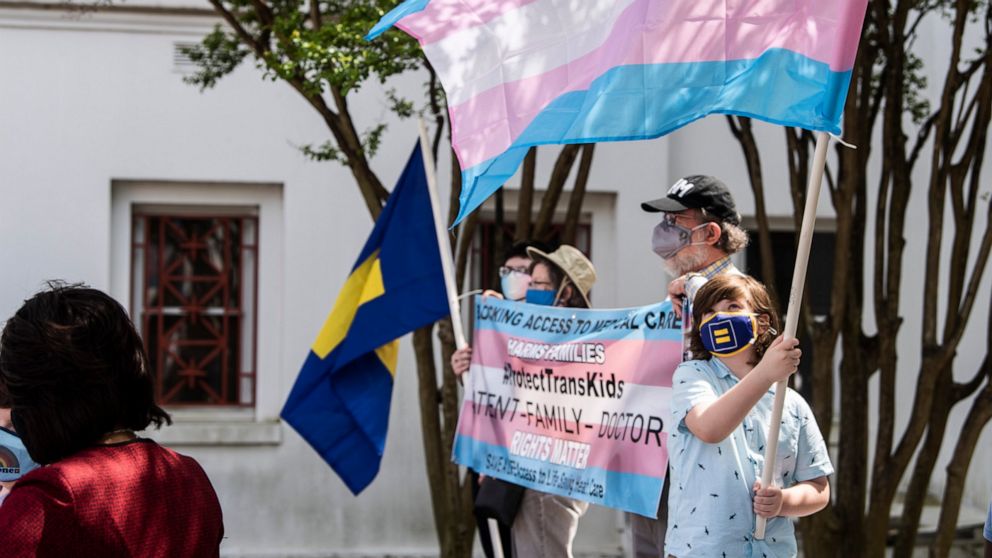 FILE - Protestors in support of transgender rights rally outside the Alabama State House in Montgomery, Ala., March 30, 2021. Three days after the U.S. Supreme Court ruled that states can prohibit abortion, Alabama seized on the decision to argue tha