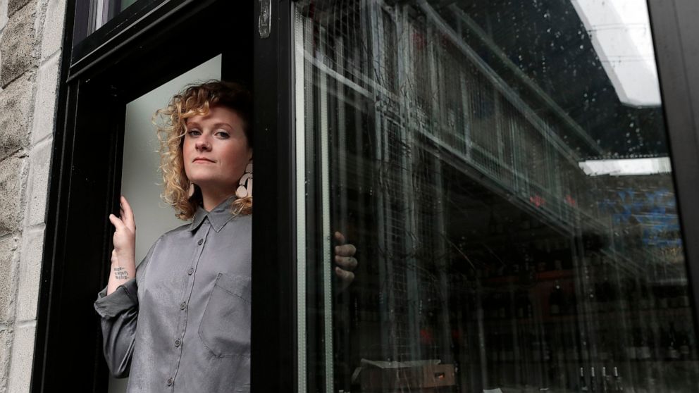 Lauren Friel, owner of Rebel Rebel Wine Bar, in Somerville, Mass., stands for a portrait at the wine bar, Thursday, April 2, 2020. An Associated Press review of the small business aid passed by Congress as part of its coronavirus stimulus package sho