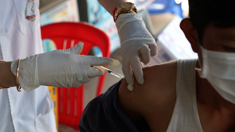 A Cambodian nurse gives a shot of fourth dose of the Pfizer's COVID-19 vaccine at a heath center in Phnom Penh, Cambodia, Friday, Jan. 14, 2022. Cambodia on Friday began a fourth round of vaccinations against the coronavirus, following the recent dis