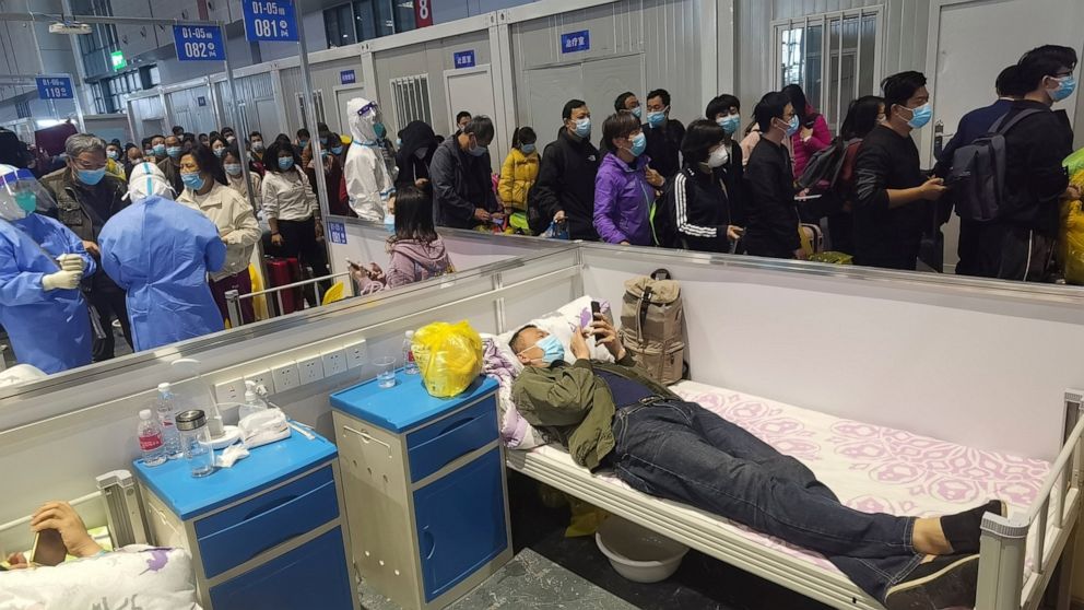 People who have been negative in the last two nucleic acid tests line up to leave a temporary hospital converted from the National Exhibition and Convention Center to quarantine COVID-positive people in Shanghai, China on April 18, 2022. Interviews w