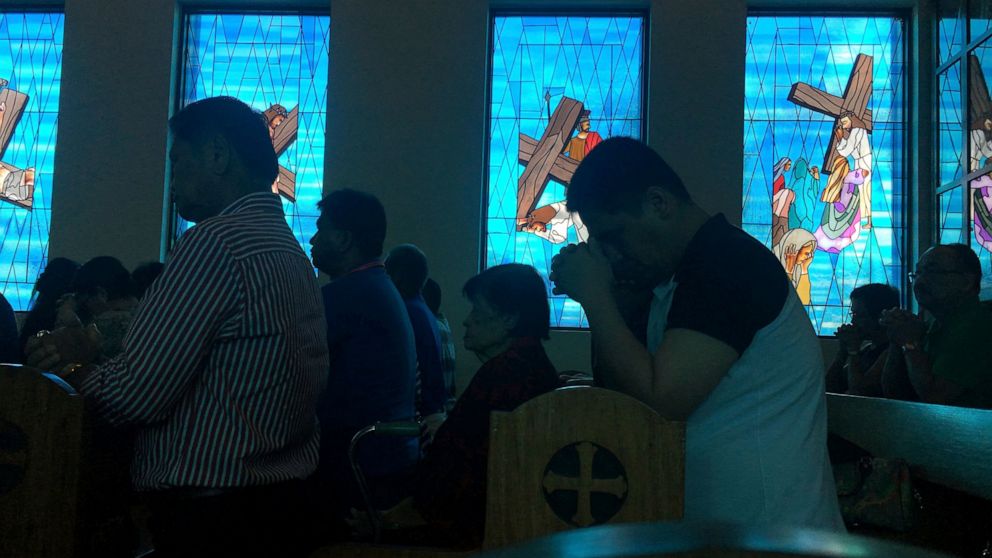 FILE - In this Aug. 13, 2017, file photo, worshippers attend Sunday Mass at Blessed Diego de San Vitores Church in Tumon, Guam. No doctors are willing to perform abortions in the U.S. territory of Guam, and the island's first female governor is conce