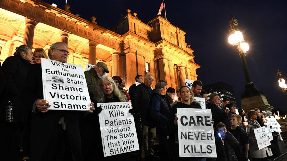 In this Tuesday, June 18, 2019, photo, pro life demonstrators gather outside the Victorian State Parliament, opposing the voluntary assisted dying laws, in Melbourne. Voluntary euthanasia became legal in an Australian state on Wednesday, June 19, mor