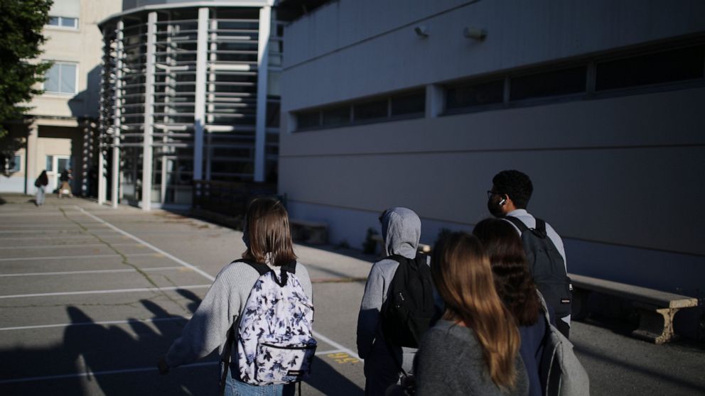 Students arrive at school in Arles, southern France, Monday, May 3, 2021. Students go back to secondary and high schools and a domestic travel ban will end. The French government is slowly starting to lift partial lockdowns, despite still high number