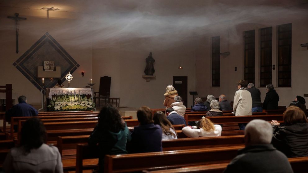 Incense fills the air as worshipers pray for a good outcome of a parliamentary vote on euthanasia during a vigil at a church in Oeiras, outside Lisbon, Wednesday, Feb. 19, 2020. Portugal's parliament is debating Thursday whether to allow euthanasia a