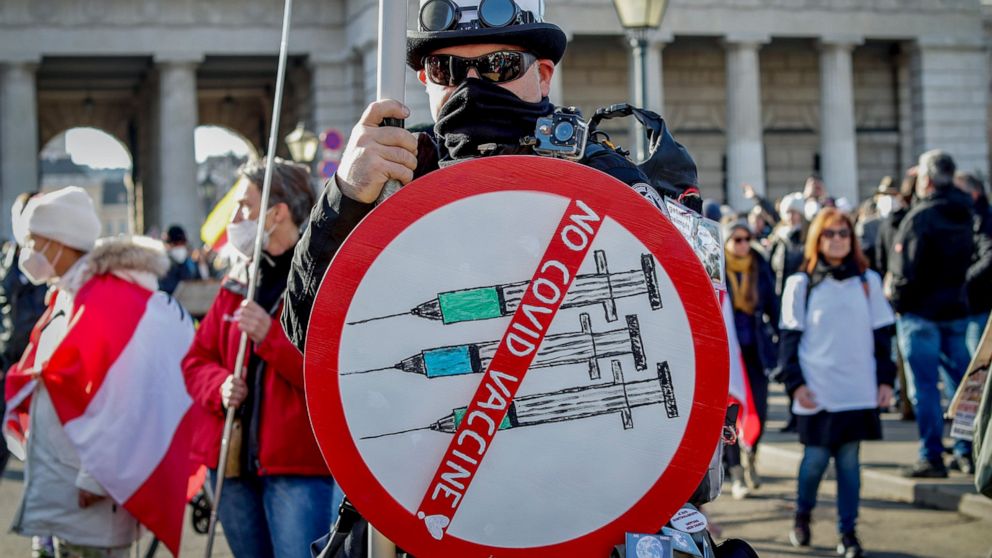 FILE - A man takes part in a demonstration against the country's coronavirus restrictions in Vienna, Austria, Saturday, Nov. 20, 2021. The coronavirus's omicron variant kept a jittery world off-kilter Wednesday Dec. 1, 2021, as reports of infections 